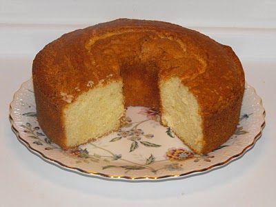 a bundt cake on a plate with one slice cut out