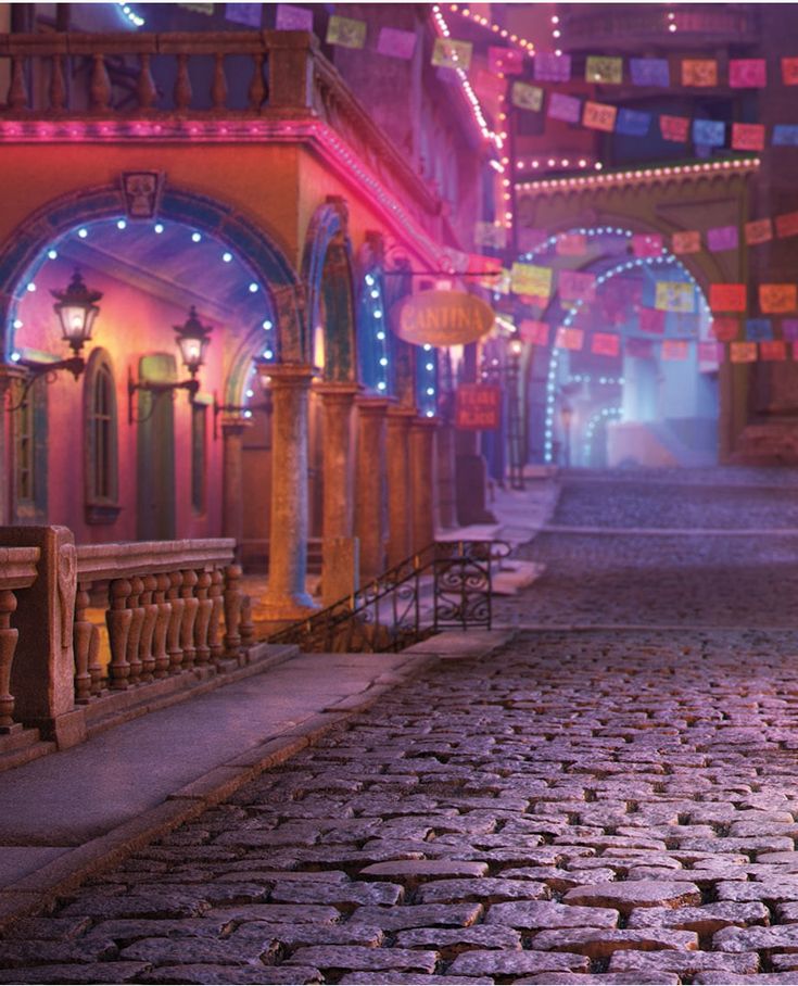 an alley way with lights and decorations on the walls, cobblestone flooring