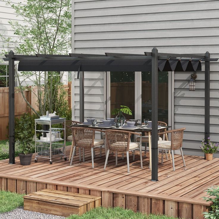 an outdoor dining area with wooden decking and pergolated patio furniture on it