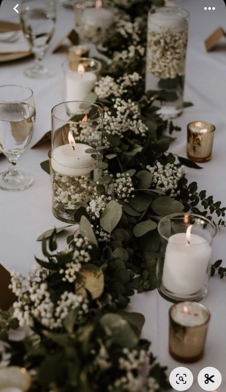 a long table with candles and flowers on it