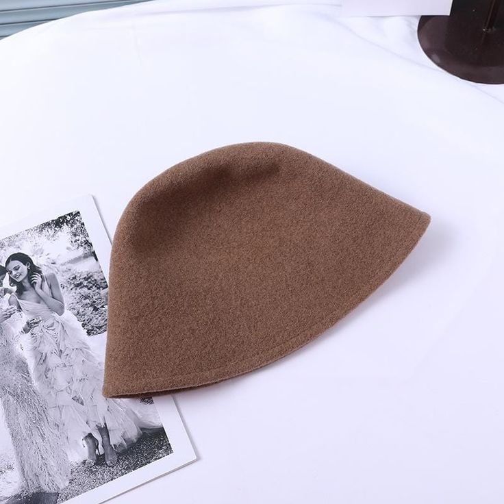 The EMES SHOP hat is detailed with a simple silhouette. Features a wool material and cloche hat design.MATERIAL:100% Brushed Wool BlendCIRCUMFERENCE MEASUREMENTS: 56-58cm 22-23in Classic Solid Color Cloche Hat For Fall, Classic Solid Cloche Hat For Fall, Classic Fall Cloche Hat, Beige Short Brim Felt Hat For Winter, Beige Felt Hat With Short Brim For Winter, Solid Wool Fedora Hat, Winter Felt Cloche Hat With Short Brim, Winter Beige Wool Felt Hat, Solid Color Wool Brimmed Hat