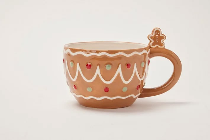 a coffee cup with a cookie on the side is sitting in front of a white background