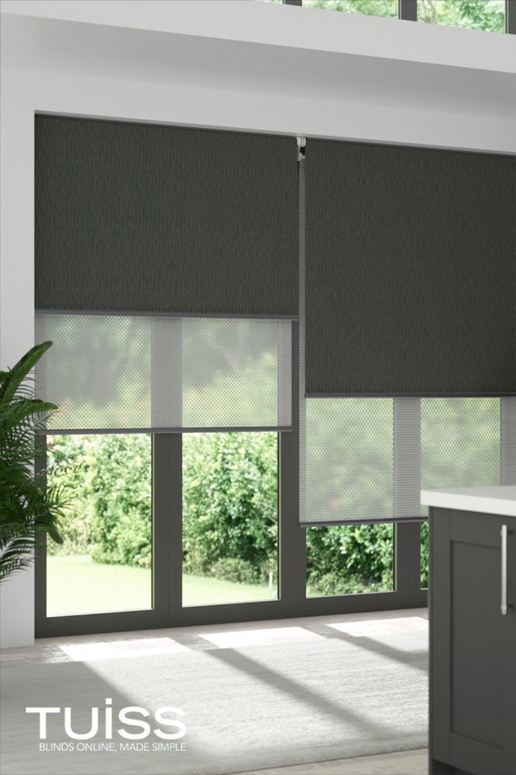 Image shows large windows covered with double roller blinds. The double roller blinds feature two fabric layers. One is a blockout for complete light control and privacy, ideal for nighttime - this shows the blockout roller in a charcoal. The second layer is a sunscreen fabric which is sheer, to cut the glare of the sun during the day and provide daytime privacy, without losing daylight or a view to the outdoors. Modern Blinds Living Rooms, Roller Shades Living Room, Modern Window Blind, Large Windows Living Room, Curtains Design Ideas, Blinds And Curtains Living Room, Roller Blinds Living Room, Blinds For Large Windows, Roller Blinds Bedroom