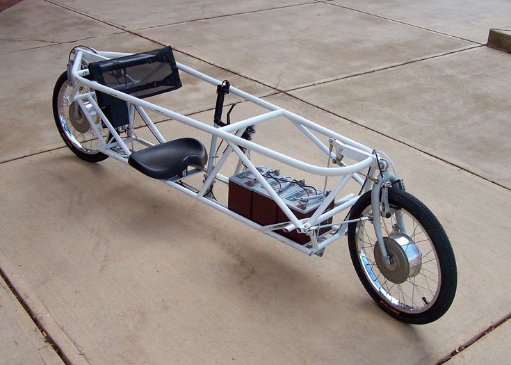 a small white bike with a side car attached to it's front wheel and seat