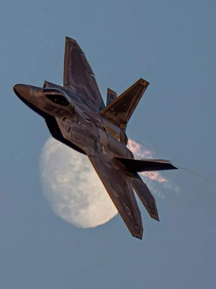 a fighter jet flying in front of the moon