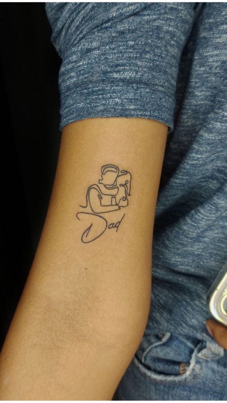 a person with a small tattoo on their arm