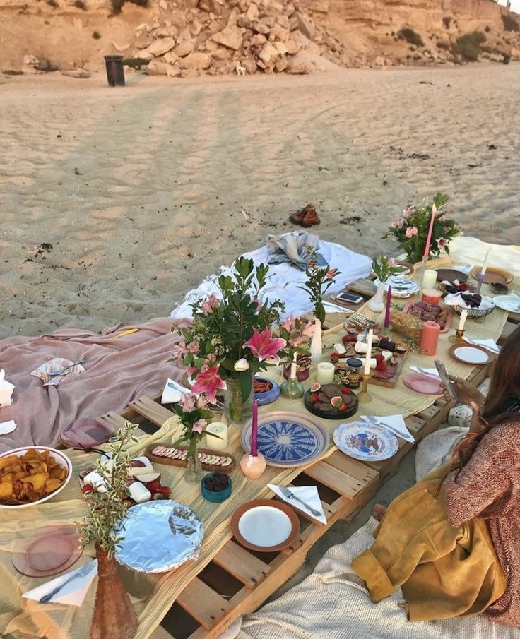 a woman sitting at a table with food on it