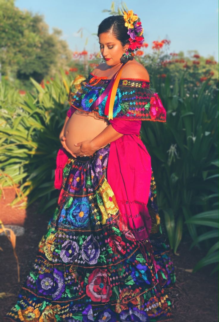 a pregnant woman in a colorful mexican dress