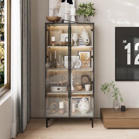 a glass cabinet in the corner of a living room