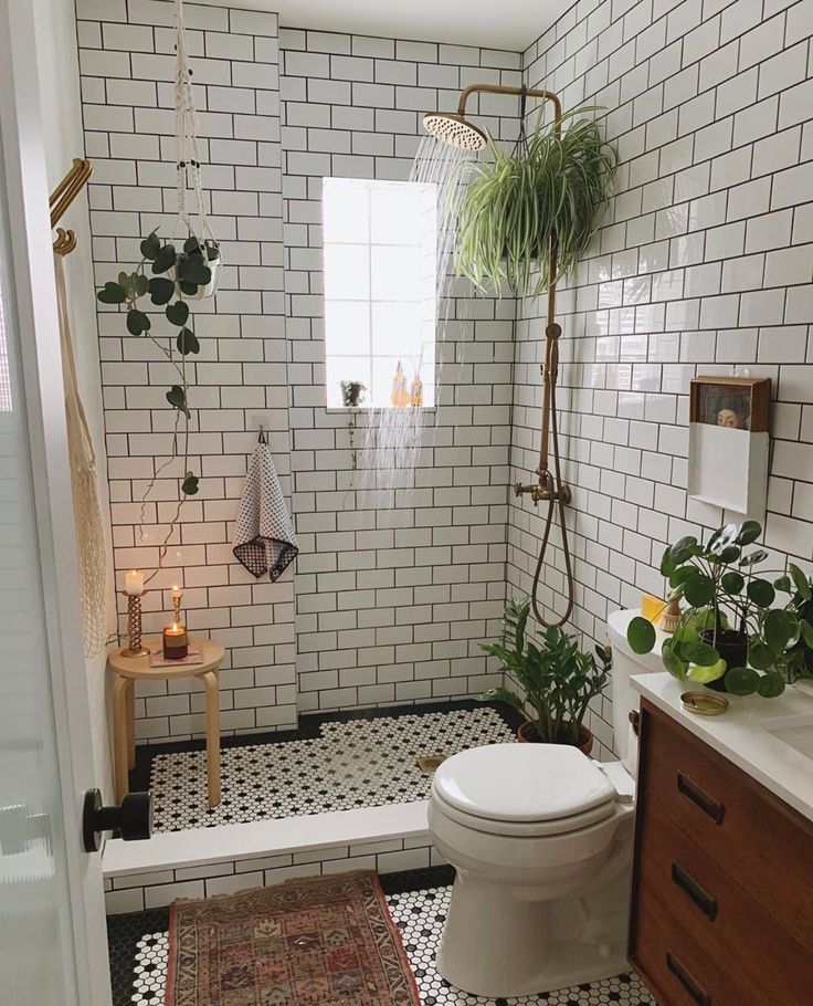 a white toilet sitting next to a shower in a bathroom