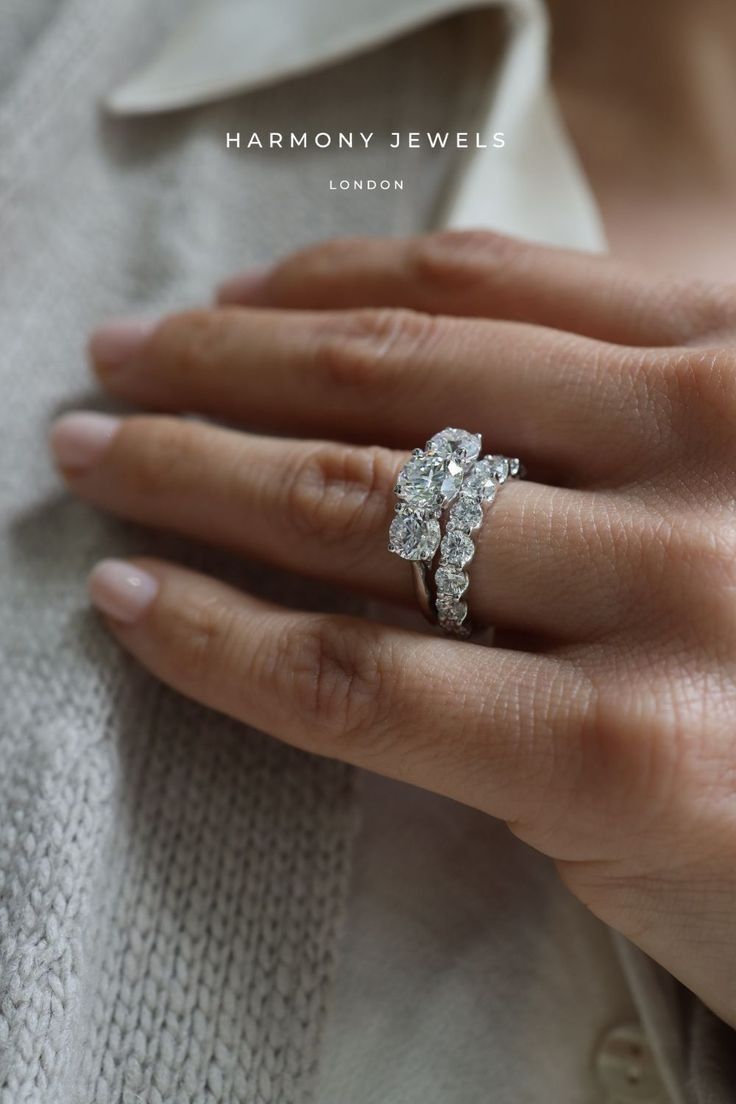 a woman's hand with a diamond ring on top of her finger and the words harmony jewels