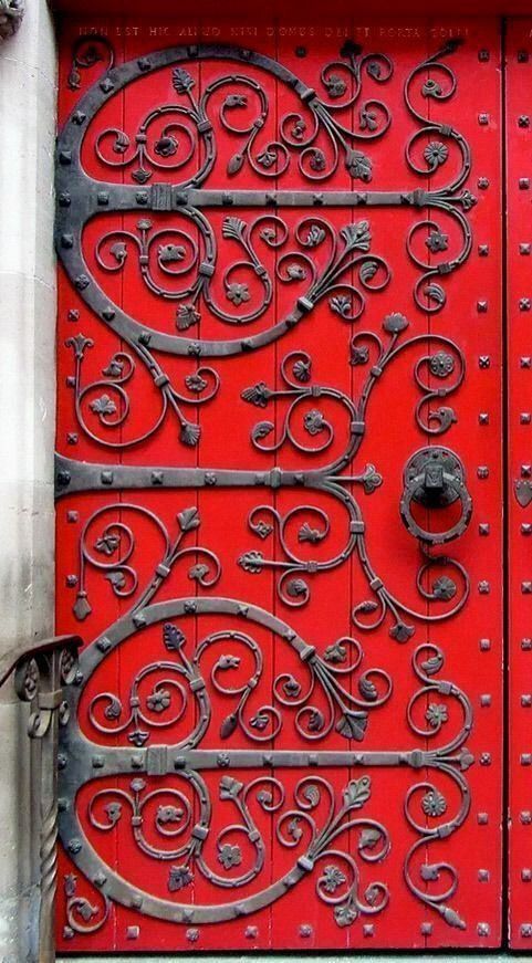 a red door with intricate iron work on it