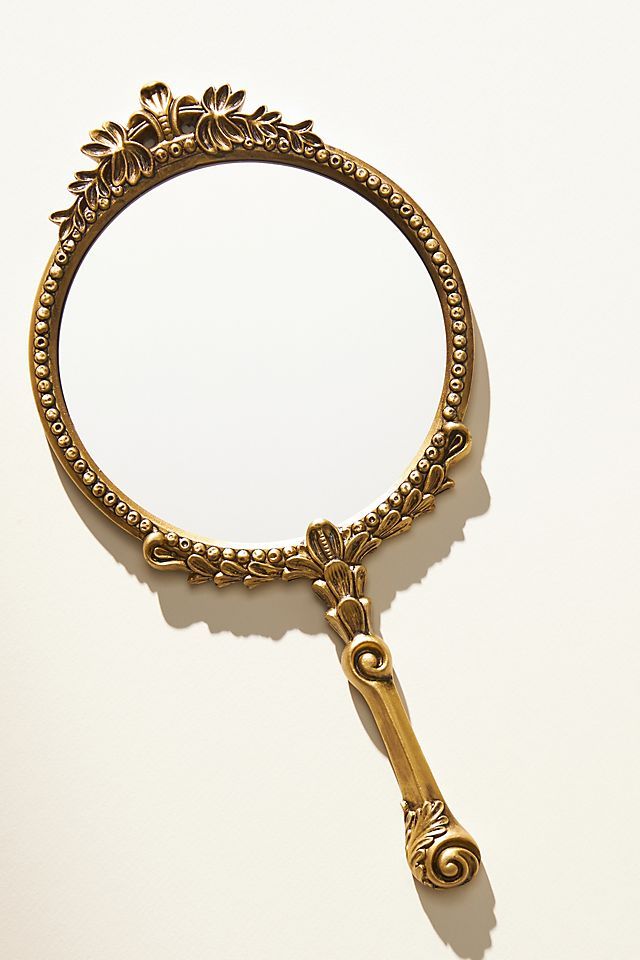 an antique looking magnifying glass on a white surface