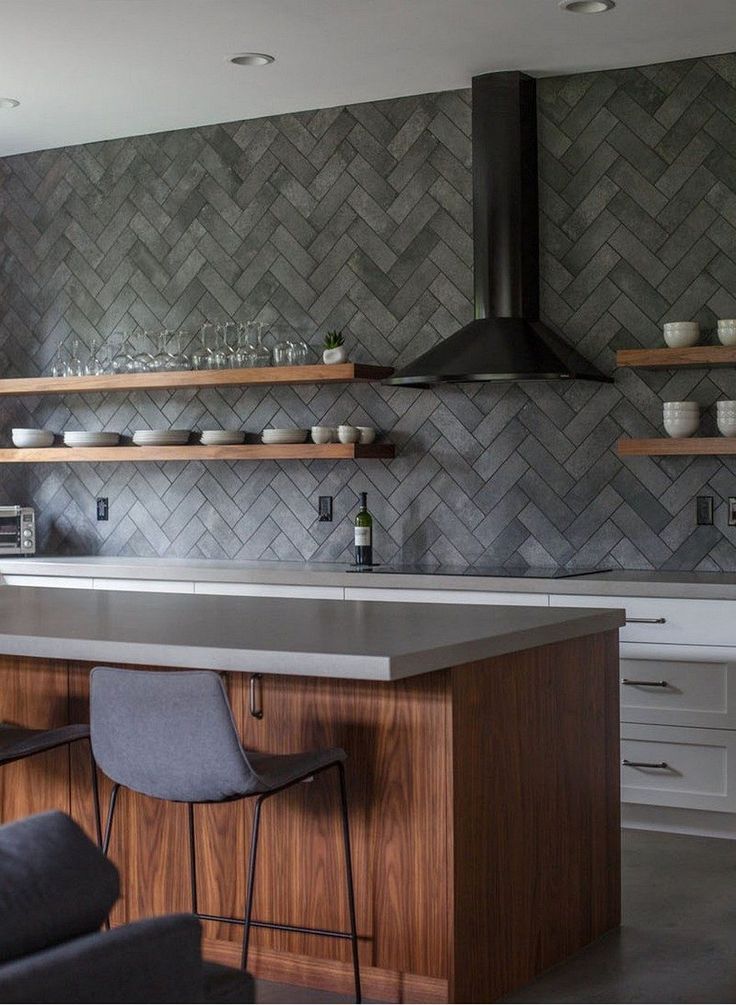 a kitchen with an island and shelves filled with dishes on top of it's counter tops