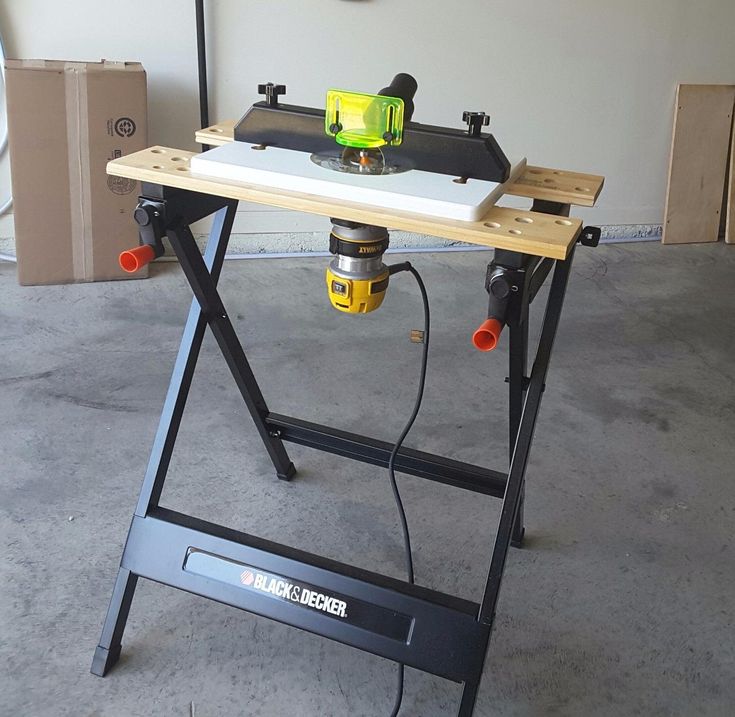 a workbench sitting on top of a table with a driller next to it