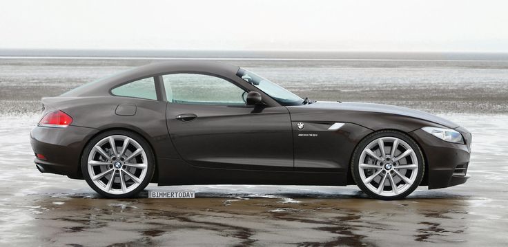 the bmw z4 roadster is parked in some icey water near an ocean