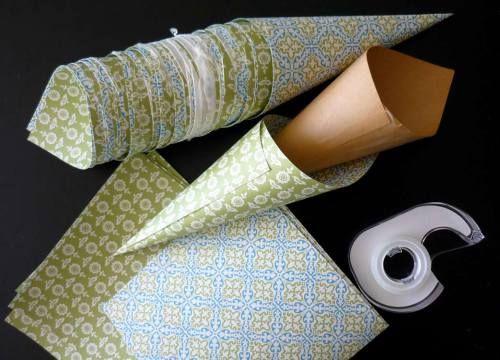 two rolls of toilet paper next to a roll of tape on a black table top