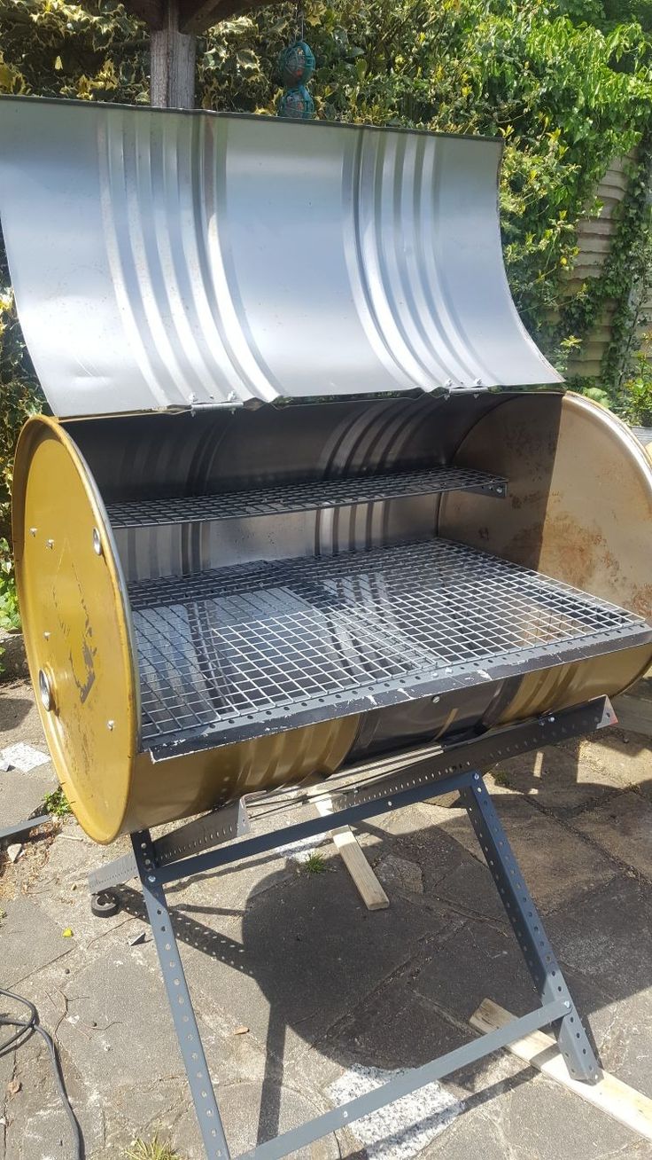 an outdoor grill is shown with the lid open and it's grilling tray on top