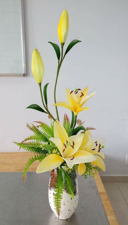 a vase filled with yellow flowers on top of a table