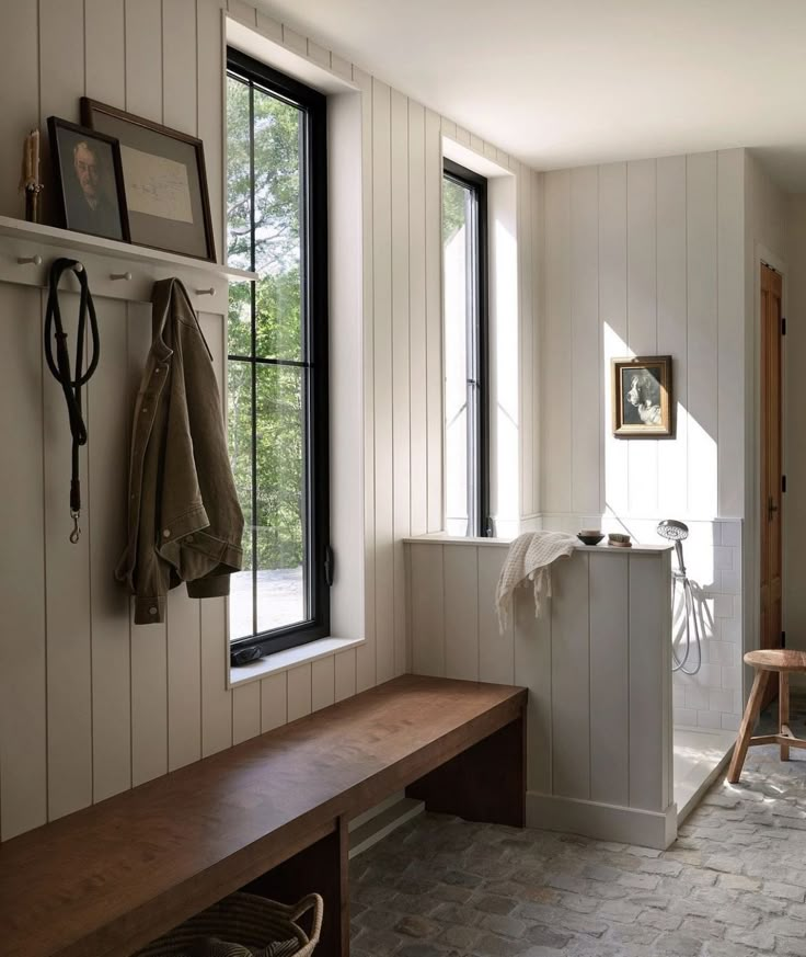 a wooden bench sitting next to a window