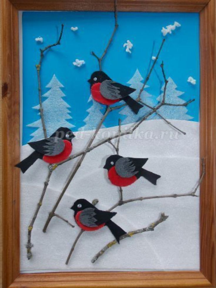 three birds are sitting on branches in the snow