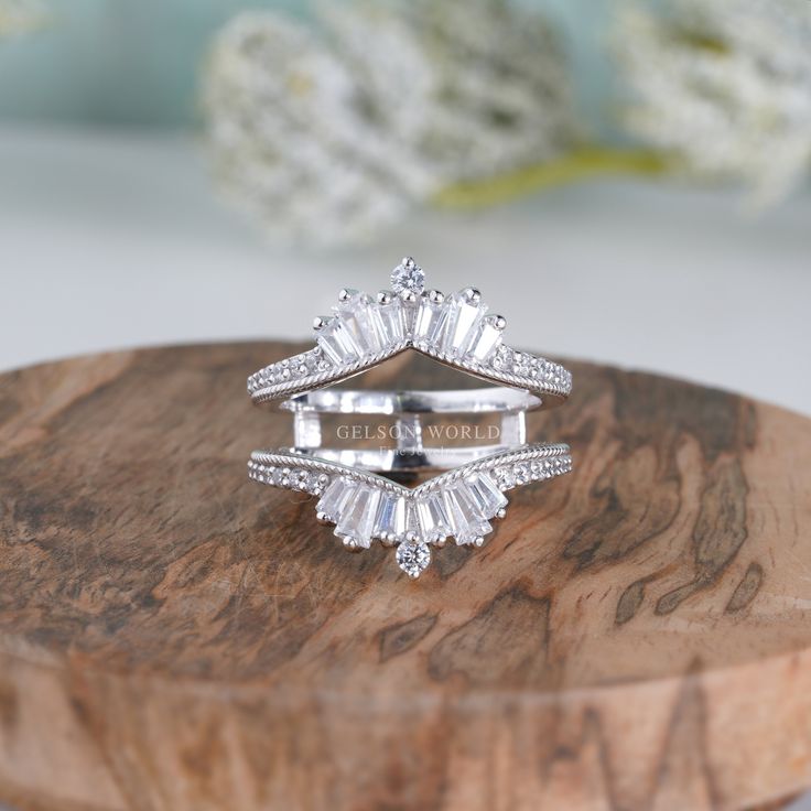 a diamond ring sitting on top of a wooden stand