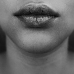 a woman's lips are shown in black and white