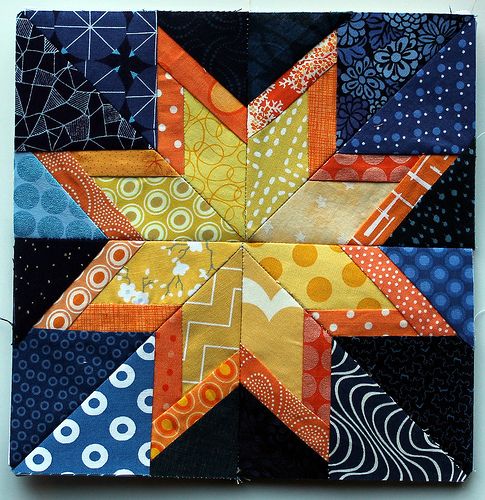 a colorful patchwork star on a white surface