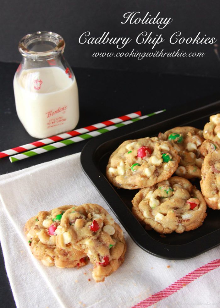 some cookies are on a tray next to a glass of milk and candy canes