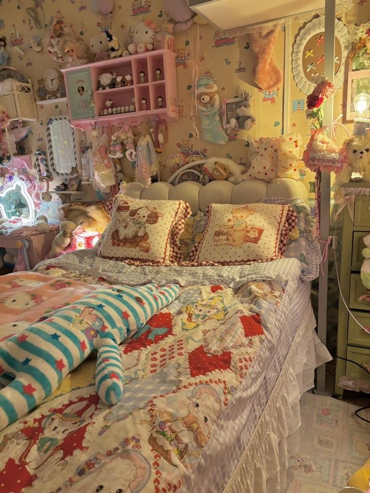 a bedroom with teddy bears and other stuffed animals on the wall above the bedspread