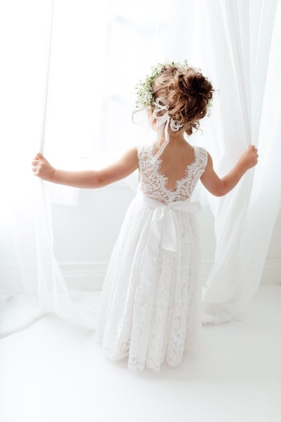 This stunning dress is a beautiful vintage inspired look...perfect for any little girl and occasion! This white dress has a boho flair and a super feminine feel with the soft vintage inspired lace. The V back with unfinished lace and hem creates the perfect amount of bohemian vibes. Nicolettes Lace Flower Girl Dress Rustic, White Lace Dress Long, Flower Girl And Ring Bearer, Flower Girl Proposal, Girl Ring Bearer, Flower Girl Hair, Flower Girl Ring Bearer, Ivory Flower Girl, Ivory Flower Girl Dresses