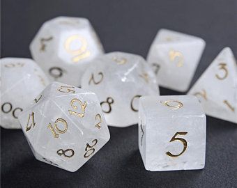 white and gold dice with numbers on them