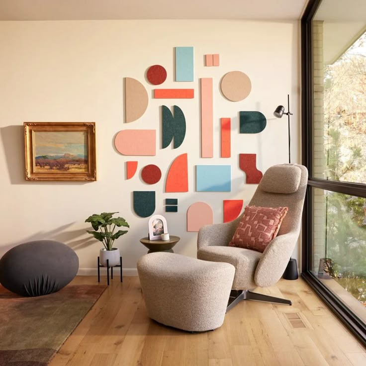 a living room filled with furniture and paintings on the wall