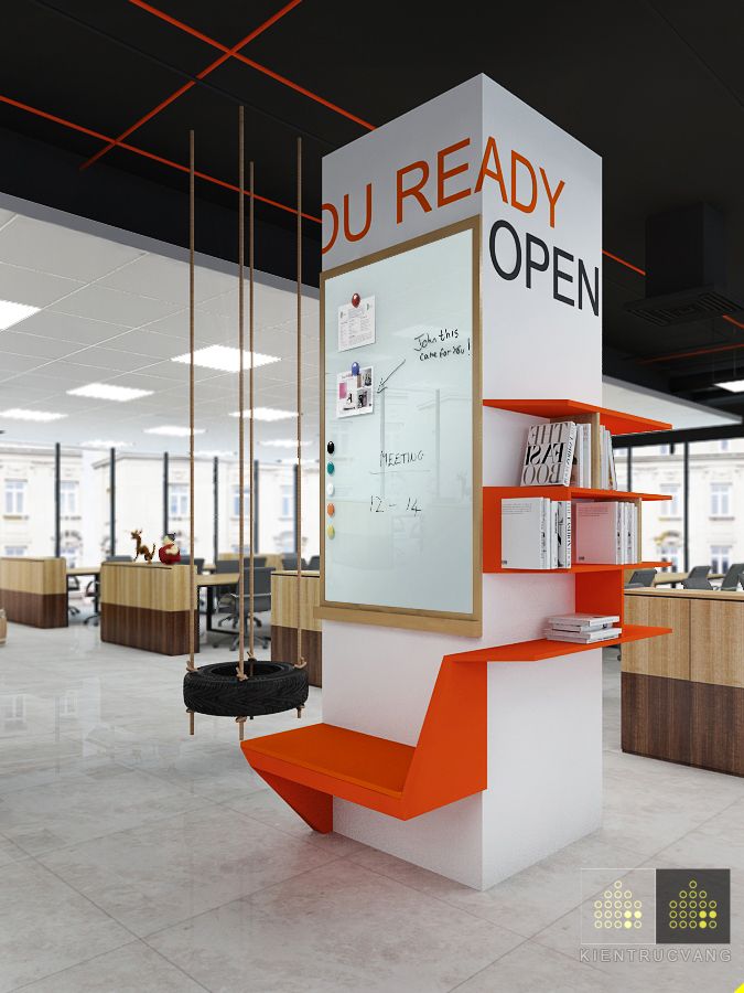 an orange and white display case in the middle of a large open office space with lots of desks