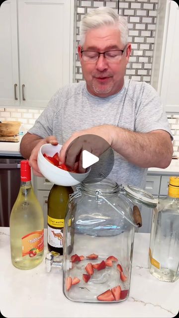 a man is making something in a bowl on top of a kitchen counter with other ingredients