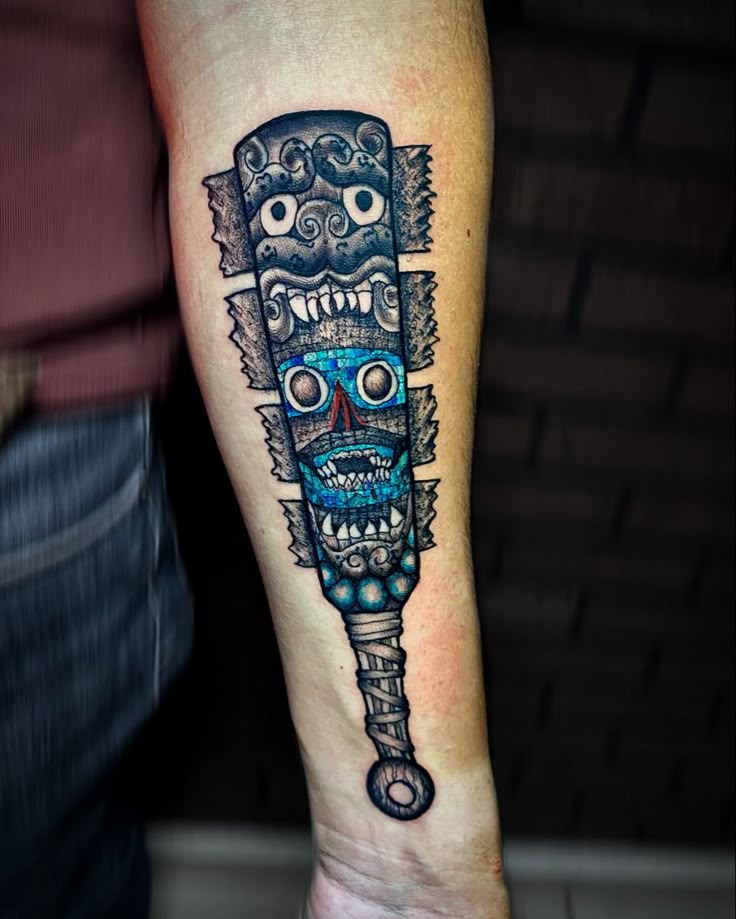 a tattoo on the leg of a man with a blue and black skull head in it