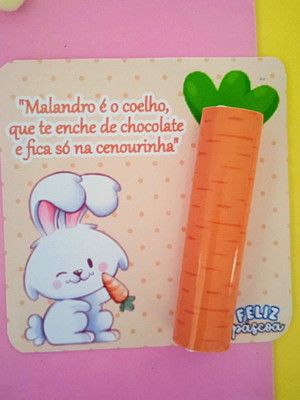 a carrot with a bunny holding a carrot in it's mouth next to a sticker