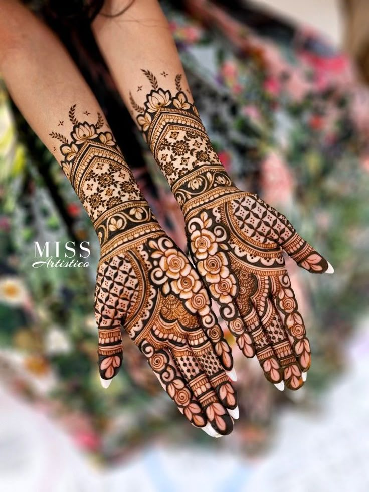 the hands and feet of a woman are decorated with henna designs on their palms