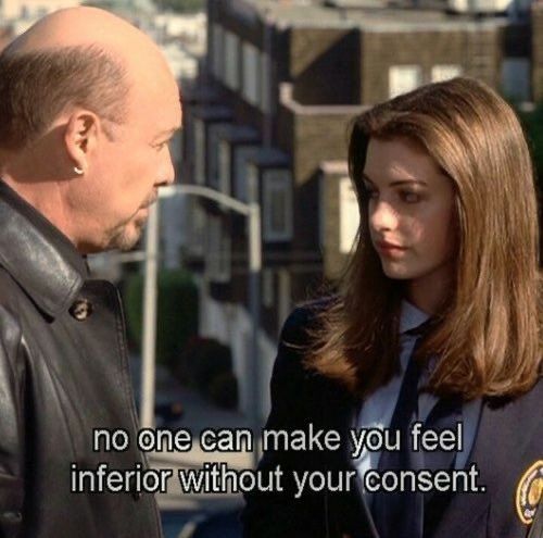 a man and woman standing next to each other in front of a building with the words, no one can make you feel inferior