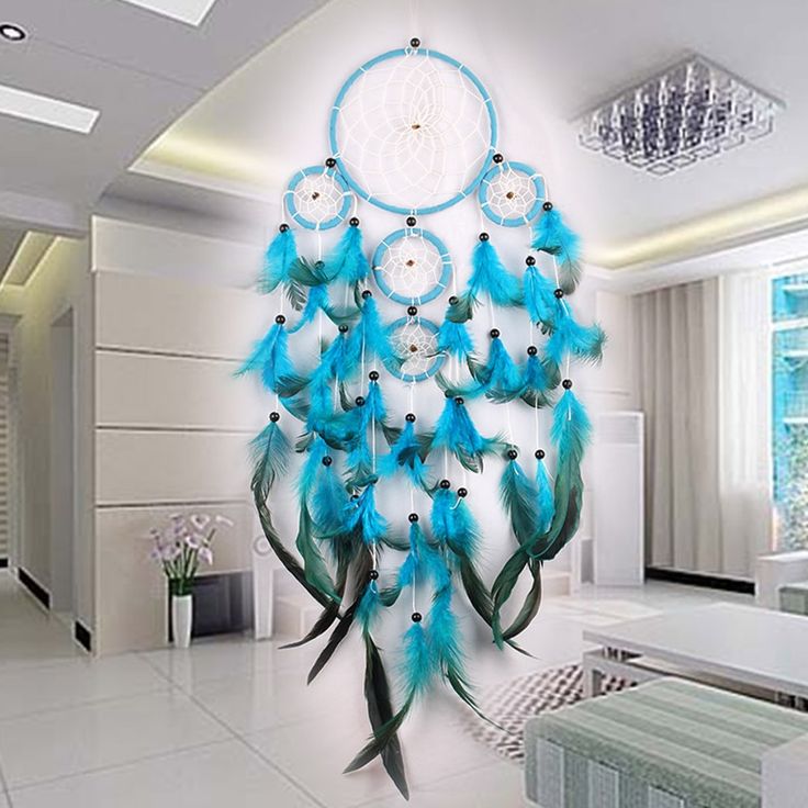 there is a blue and white dream catcher hanging on the wall in this living room