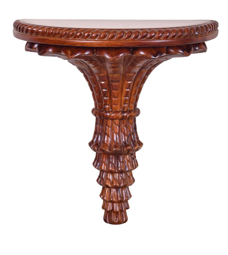 an ornate wooden table with intricate carvings on the top and bottom, against a white background