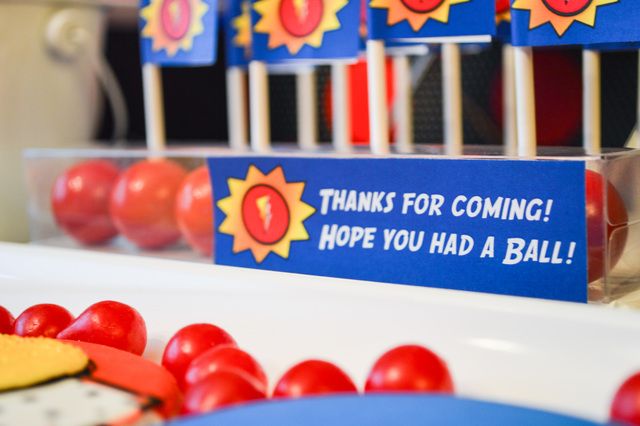 there are some red tomatoes on the table and blue signs that say thanks for coming hope you had a ball