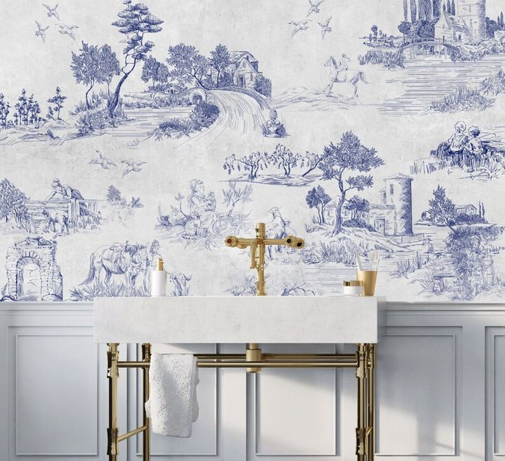 a white sink sitting next to a wall covered in blue and white wallpapers