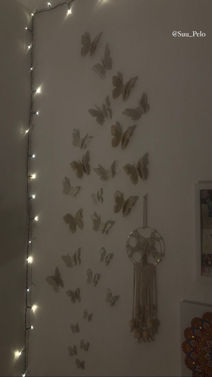 the wall is decorated with butterflies and lights