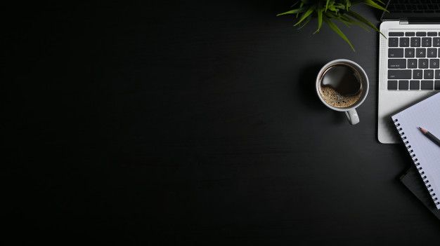 an open laptop computer sitting on top of a desk next to a cup of coffee