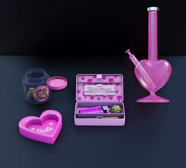 an assortment of pink items including a pipe, heart shaped container and other accessories on a black surface