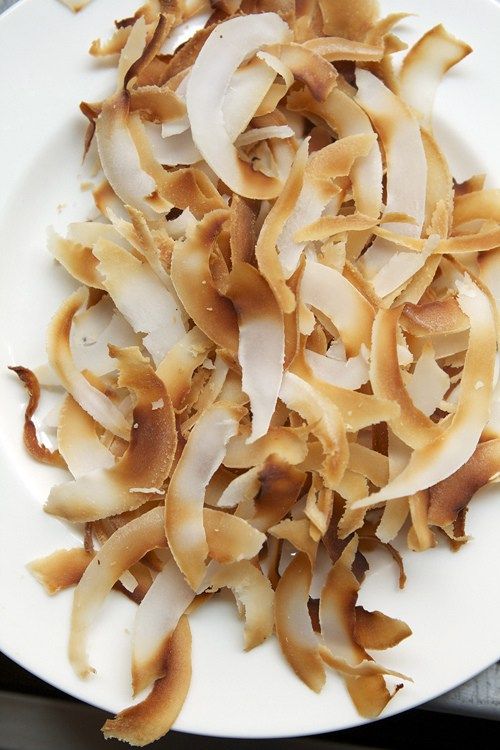 a white plate topped with sliced onions on top of a table