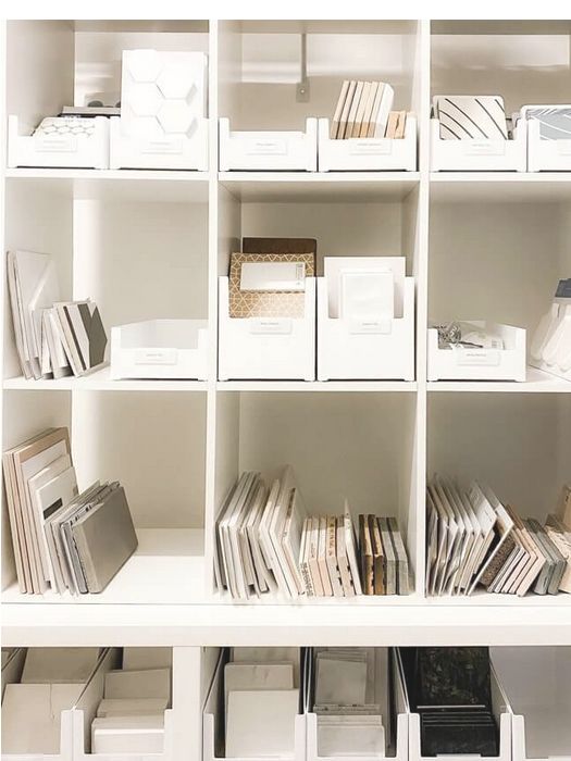 a white bookcase filled with lots of books on top of it's shelves