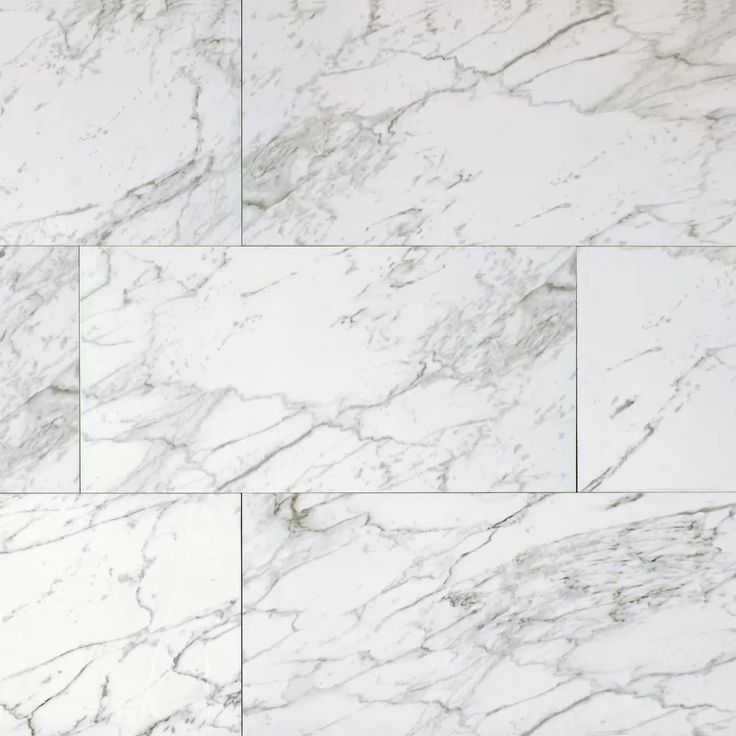 a white marble tile wall that looks like it has been polished