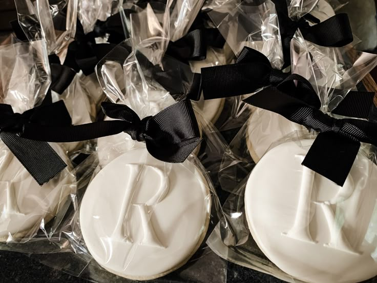 some white cookies with black ribbons on them